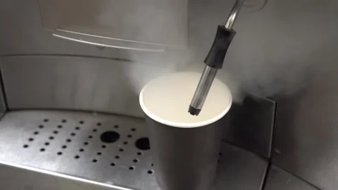 The process of steaming milk to create creamy foam for coffee drinks. The steam Stock Footage 332227680