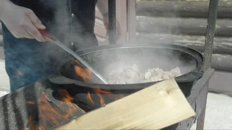 Process of stewing lamb meat for pilaf on open fire in yard Stock Footage 247436266