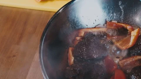 The process of stewing meat and vegetables in a deep frying pan Stock Footage 73213744