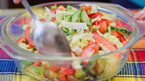 Process of stirring vegetable salad with steel spoon Stock Footage 171849356