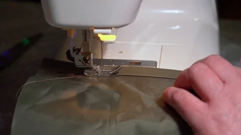 The process of stitching khaki material on a modern sewing machine Stock Footage 122523795