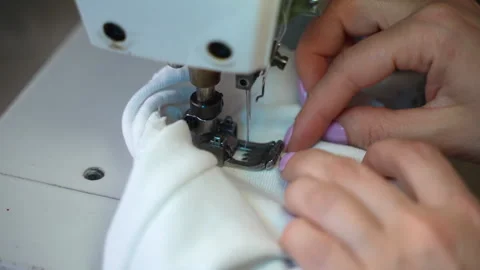 Process of stitching white fabric with sewing needle and threads creating Video stock 250018729