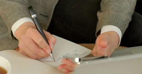Process of strategizing and organizing. Close-up hand making notes in planner. Stock Photos