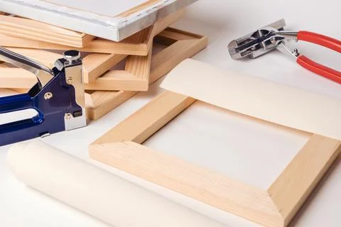 The process of stretching the canvas on a stretcher in the framework shop. Ca Stock Photos
