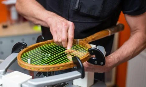 Process of stringing a historic or retro tennis racket in a tennis shop, sport Stock Photos