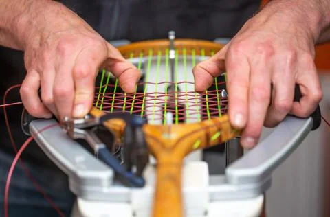 Process of stringing a historic or retro tennis racket in a tennis shop, sport Stock Photos