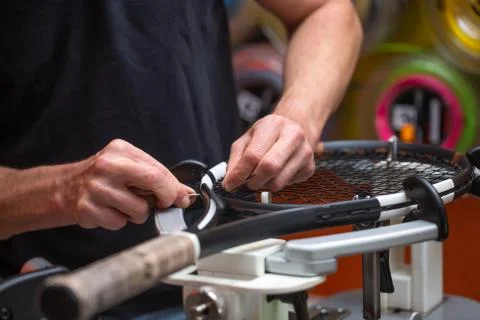 Process of stringing a tennis racket in a tennis shop, sport and leisure concept 库存照片