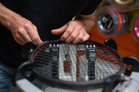 Process of stringing a tennis racket in a tennis shop, sport and leisure concept Stock Photos