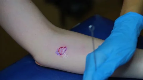 The process of stuffing a tattoo close-up. Hand poke tattoo close-up. Stuffing a Stock Footage 214494346