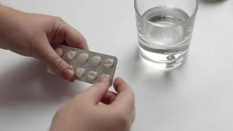 The process of taking a medicine close-up, human hands take out a pill and take Stock Footage 146959829