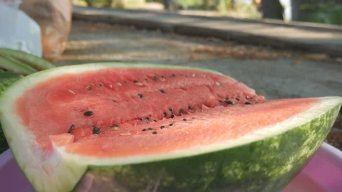 Process of tasting of watermelon. Knife cuts flesh and hand takes it to eat Stock Footage 121689557