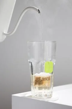 The process of tea infusion captured mid-pour, serene. Stock Photos