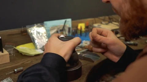 Process of teaching the fastening of precious stones in a silver ring with a Stock Footage 73528727