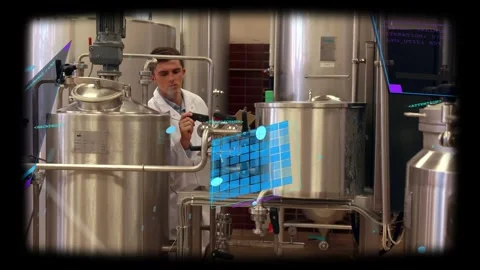 Process technician grasping tank valve and adjusting flow at pilot plant while Stock Footage 331713654