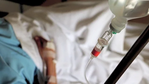 Process of therapy for patient lying on bed in hospital room. Stock Footage 93779167
