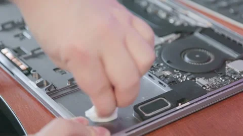 The process of thoroughly cleaning the inside of a metal laptop case with an Stock Footage 336517474