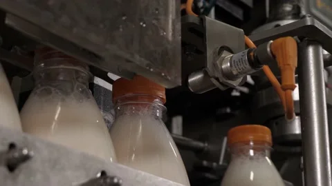 The process of tightening the lids on bottles with melted milk Stock Footage 170667970
