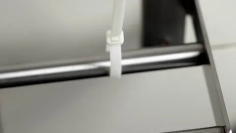 The process of tightening a plastic cable tie Stock Footage 263055827