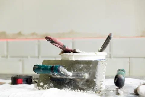 Process of tiling the tiles in the kitchen with necessary tiling tools. Home Stock Photos