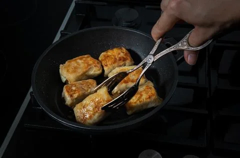 Process of turning and frying the cabbage rolls Stock Photos