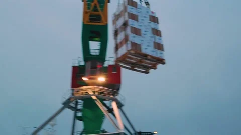 The process of unloading a cargo ship at the berth with a large unloading crane Stock Footage 144888747