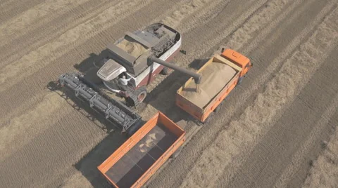 Process of unloading grain from combine to harvest in back of a truck Stock Footage 64258292