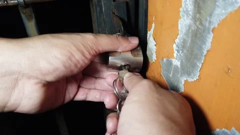 The process of unlocking the fence padlock Stock-Footage 197369200