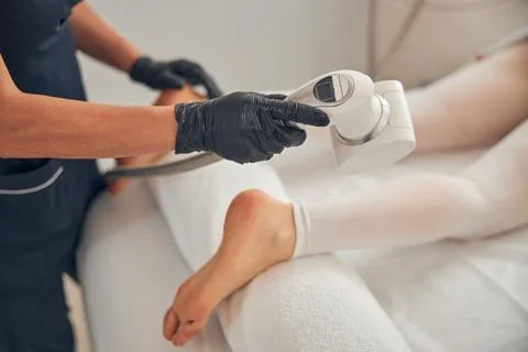 Process of using special device for reducing fat on legs Stock Photos