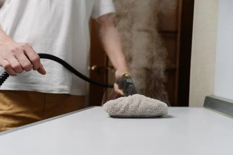 Process using steam cleaner, sanitizing kitchen countertop with modern Stock Photos