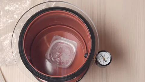 The process of vacuum degassing of liquid. Epoxy resin in a vacuum chamber. Video stock 153547638