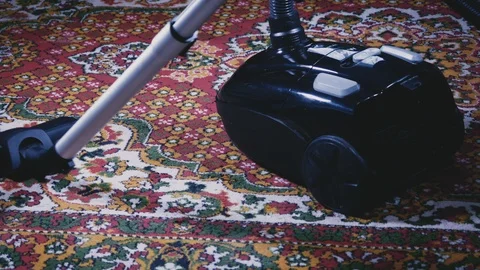 The process of vacuuming the carpet in the dining room close-up Stock Footage 102304463
