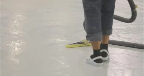 The process of vacuuming a polymer floor after finishing work. Cleaning the Stock Footage 274468633