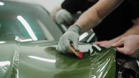 Process of vinyl wrapping a car in khaki green color using plastic cards Stock Footage 171961345