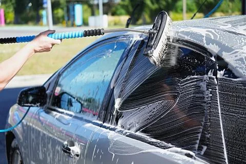 The process of washing a car using foam and a brush Stock Photos