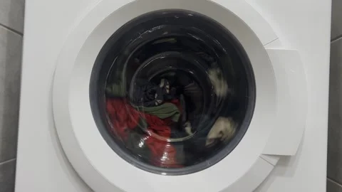 The process of washing things in a washing machine. Clothes are washed in a Stock Footage 275242442