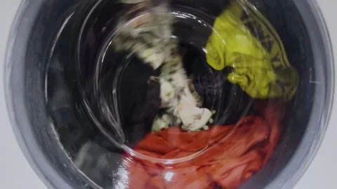 The process of washing things in a washing machine. Clothes are washed in a Stock Footage 275242496