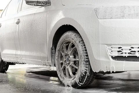 The process of washing a white car at a self-service car wash Stock Photos