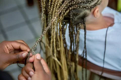 Process of weaving African with a dark-skinned hairdresser stylist Stock Photos