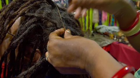 The process of weaving dreadlocks in an Indian salon. Stock Footage 129129266