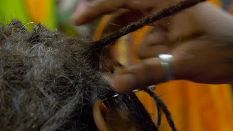 The process of weaving dreadlocks in an Indian salon. Stock Footage 129129658