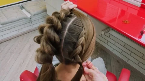 Process of weaving voluminous braids on girl head Stock Footage 326487453