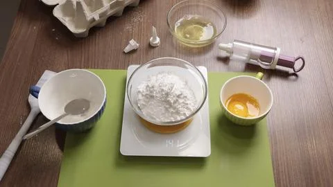 Process of weighing food on electronic scale in kitchen at home. Inventory for Stock Photos