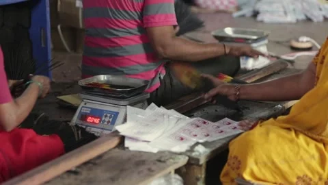 A process of weighing, packing, and sealing the incense sticks in a factory Stock Footage 241653180