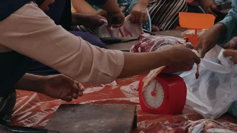 The process of weighing sacrificial meat before being distributed to recipients. Video stock 277721357