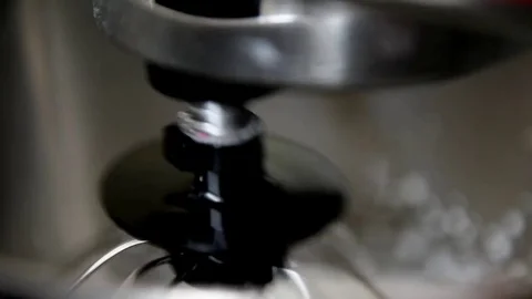 The process of whipping cream in the bowl of a professional mixer. The image is Stock Footage