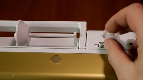 Process of winding a black thread onto a bobbin in a sewing machine Video stock 82280401