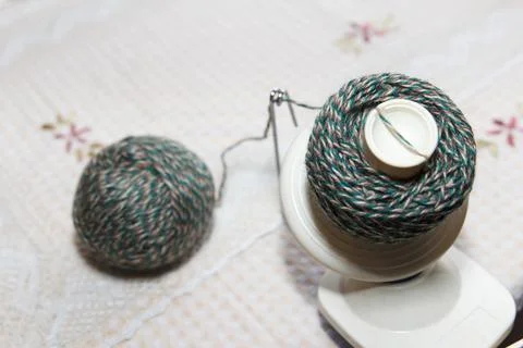 The process of winding wool green yarn from tangle to winding, using a coiler Stock Photos
