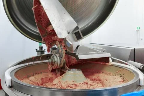Process of work big steel grinder in production of sausage in the meat plant. Stock Photos
