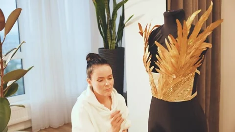 Process of work professional tailor hands close-up decorate corset on mannequin Stock Footage 328351119