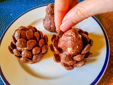 Process of working cookies. These chocolate pine cone-shaped shortbread cookies Stock Photos